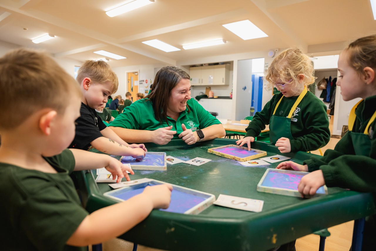 Children and teacher playing and chatting